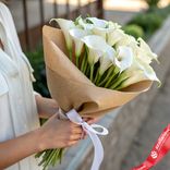 Маленькое фото 1: Букет 17 белых калл в крафте, с белой лентой