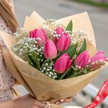 Маленькое фото 3: Букет из 7 малиновых тюльпанов с гипсофилой, в крафте, Россия