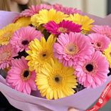 Маленькое фото 3: Букет из 17 розовых и желтых гербер в лавандовой бумаге